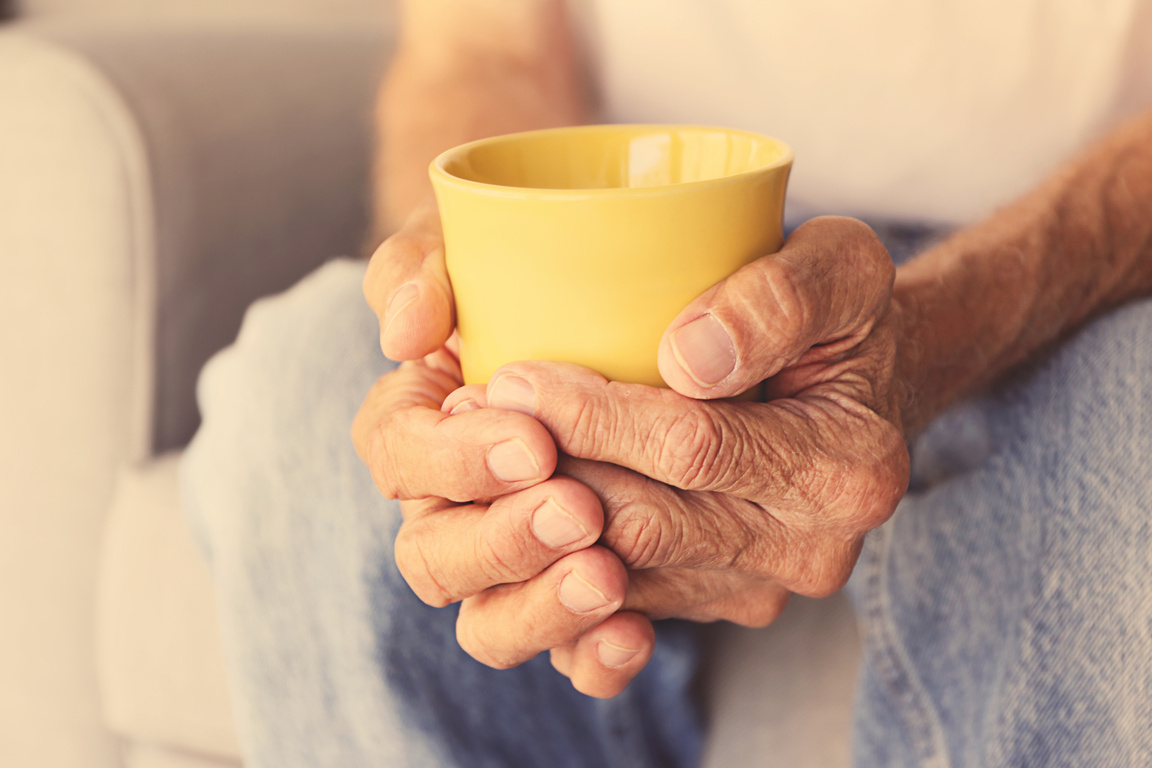 Old Man Holding Cup of Hot Drink